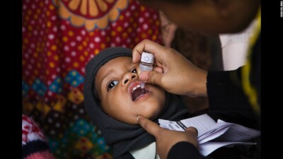 A child receives oral polio vaccine as a part of the Pulse Polio Programme